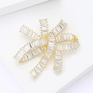 Luxurious butterfly brooch with baguette-cut zircons and gold-plated layered design