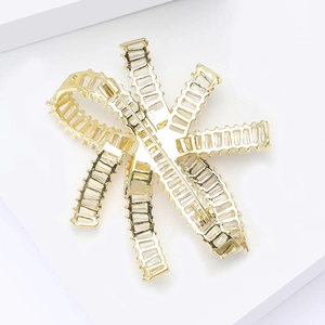 Exquisite golden bow brooch with sparkling cubic zirconia on a minimalist white stand