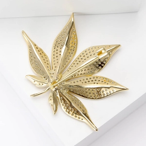 Detailansicht der Rückseite einer goldenen Ahornblatt-Brosche mit Pavé-Besatz und Nadelverschluss