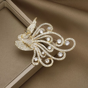 Elegant gold phoenix brooch with shimmering zircon inlay displayed in a luxury jewelry box