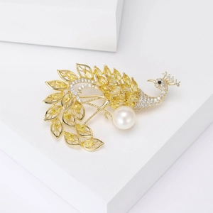 Luxurious peacock brooch with yellow zircon crystals and white pearl on gold base