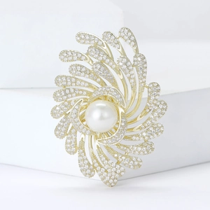 Broche feu d'artifice dorée élégante avec perle centrale et zircons scintillants