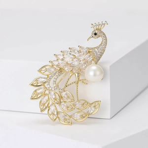Exquisite gold peacock brooch with sparkling zircons and a large white pearl detail