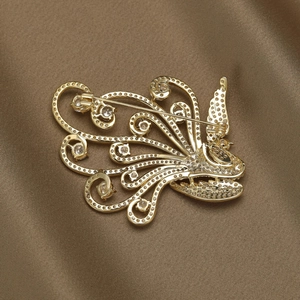 Back view of elegant phoenix brooch with golden plating and sparkling cubic zirconia