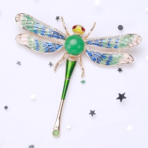 Exquisite dragonfly brooch with blue-green enamel wings and sparkling rhinestones
