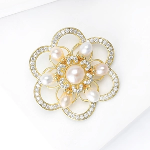 Elegant gold flower brooch with a pink pearl center and crystal camellia petals