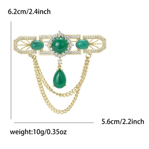 Elegant gold vintage brooch with green stones and tassels, size 6.2cm by 5.6cm detail