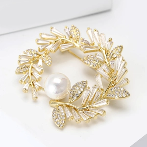 Elegant gold flower wreath brooch with sparkling zircons and a large white pearl center