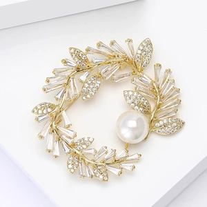 Elegant gold flower wreath brooch with sparkling zircons and a white round pearl