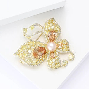 Luxury butterfly brooch with gold plating and sparkling yellow cubic zirconia crystals