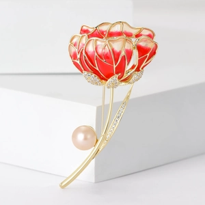 Detailed macro view of luxury enamel hibiscus brooch with pearls and inlaid zircon stones