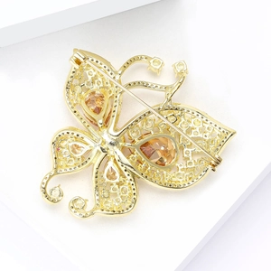 Luxury gold butterfly brooch with amber stones and intricate hollow back design