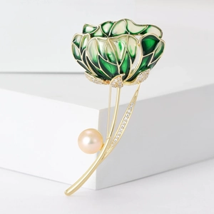 Detail of elegant enamel hibiscus flower brooch with green petals and a lustrous pearl