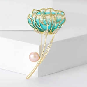 Elegant hibiscus flower brooch with blue enamel petals and a pink pearl on gold base