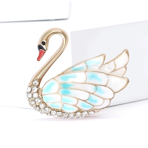 Elegant swan brooch with gold plating, white rhinestones, and blue enamel wing detail