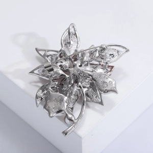 Détails du revers d'une broche fleurie montrant le fermoir et la texture étoilée