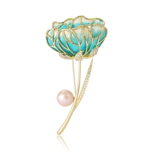Elegant gold hibiscus flower brooch with teal enamel petals and white zircon accents