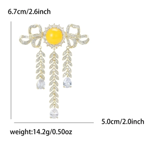 Elegant bowknot tassel brooch in gold finish with yellow stones and zircon inlay
