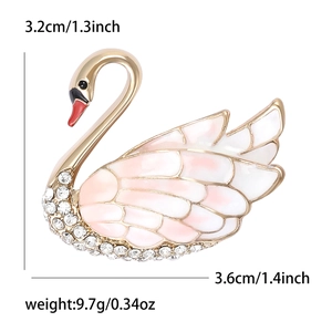 Elegant swan brooch in gold alloy with pink enamel wings and sparkling crystals