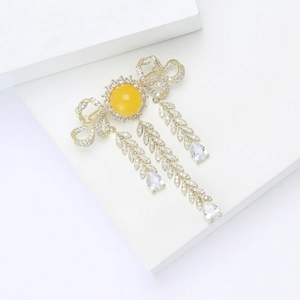 Luxury gold vintage brooch with yellow gemstone, zircon bow, and cascading leaf tassels