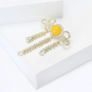 Golden bowknot tassel brooch with micro-paved zircons and yellow gemstone