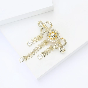 Detailed back view of luxury zircon tassel brooch showing intricate cutout and pin clasp