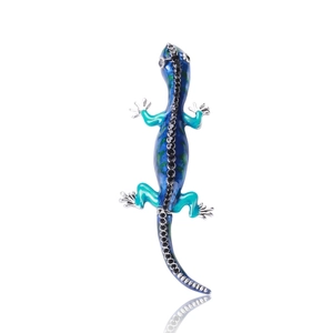 Macro detail of gecko brooch featuring blue green gradient enamel and black rhinestones