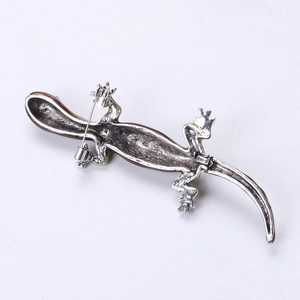 Detailed back view of lizard brooch showing silver alloy base and secure metal pin clasp