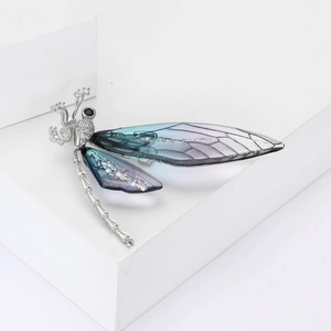 Luxury dragonfly brooch with silver-toned crystal body and blue-purple gradient wings