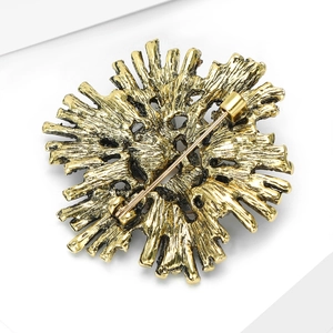 Macro view of alloy firework brooch with vintage gold finish and secure pin clasp