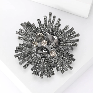 Vintage Baroque starburst brooch with dark grey rhinestones on a gunmetal base