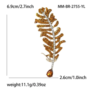 Detailed view of rhinestone feather brooch with amber crystal teardrop and size specs