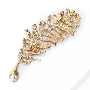 Detail view of feather brooch back showing the pin fastener and droplet zircon pendant