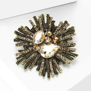 Vintage Baroque sunburst brooch with amber rhinestones on a bronze metal base