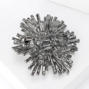 Detail view of the gun black metal brooch back showing the secure pin closure mechanism