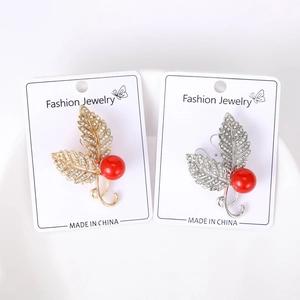 Close-up of pearl leaf brooches with micro-pave cubic zirconia on display card