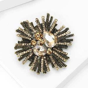 Macro detail of Baroque retro flower brooch with champagne rhinestones and bronze base