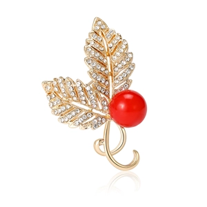 Elegant gold leaf brooch with micro-paved zircons and a large red pearl centerpiece