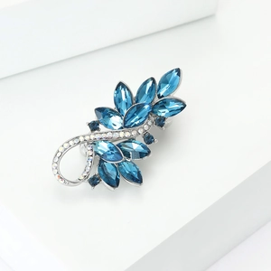 Detail shot of elegant blue marquise crystal brooch with silver base and rhinestones