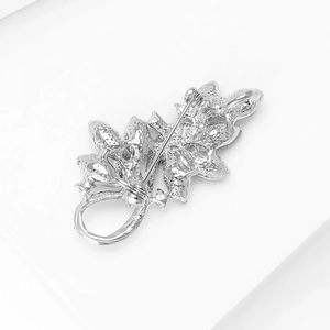 Detailed back view of silver leaf brooch showing secure safety pin clasp mechanism