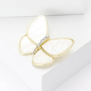 Élégante broche papillon en nacre naturelle avec des détails en strass brillants
