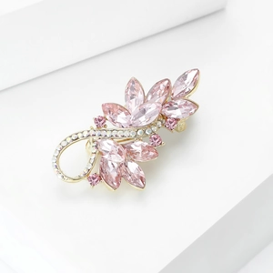 Detail of elegant pink crystal flower brooch with gold plating and white zircon tassels