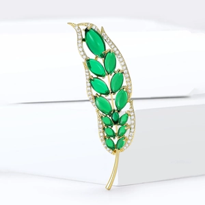 Elegant gold-tone wheat leaf brooch set with deep green marquise cut cubic zirconia