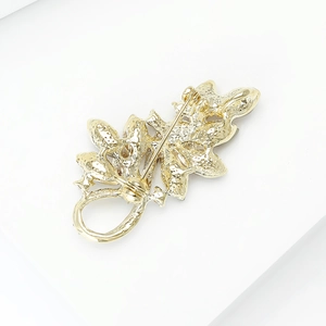 Back view of gold crystal leaf brooch showing pin clasp and detailed metal texture