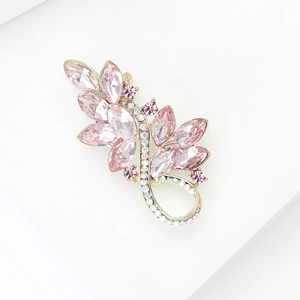 Detail of the pink crystal floral brooch with gold plating on a minimalist white surface