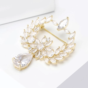 Elegant gold olive branch brooch with marquise crystals and pear-shaped drop stone