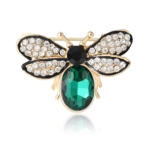 Elegant honey bee brooch in golden alloy with emerald green gemstone and crystal wings