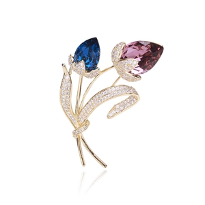 Détail de la broche tulipe avec cristaux bleus et violets sur monture dorée