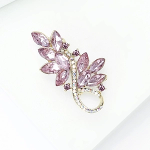 Detailed close-up of leaf brooch with purple crystals and gold alloy plating