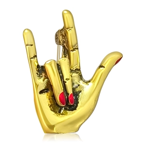 Golden creative hand gesture brooch with red fingernail detail on white background